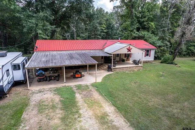 a view of a house with a yard and sitting area