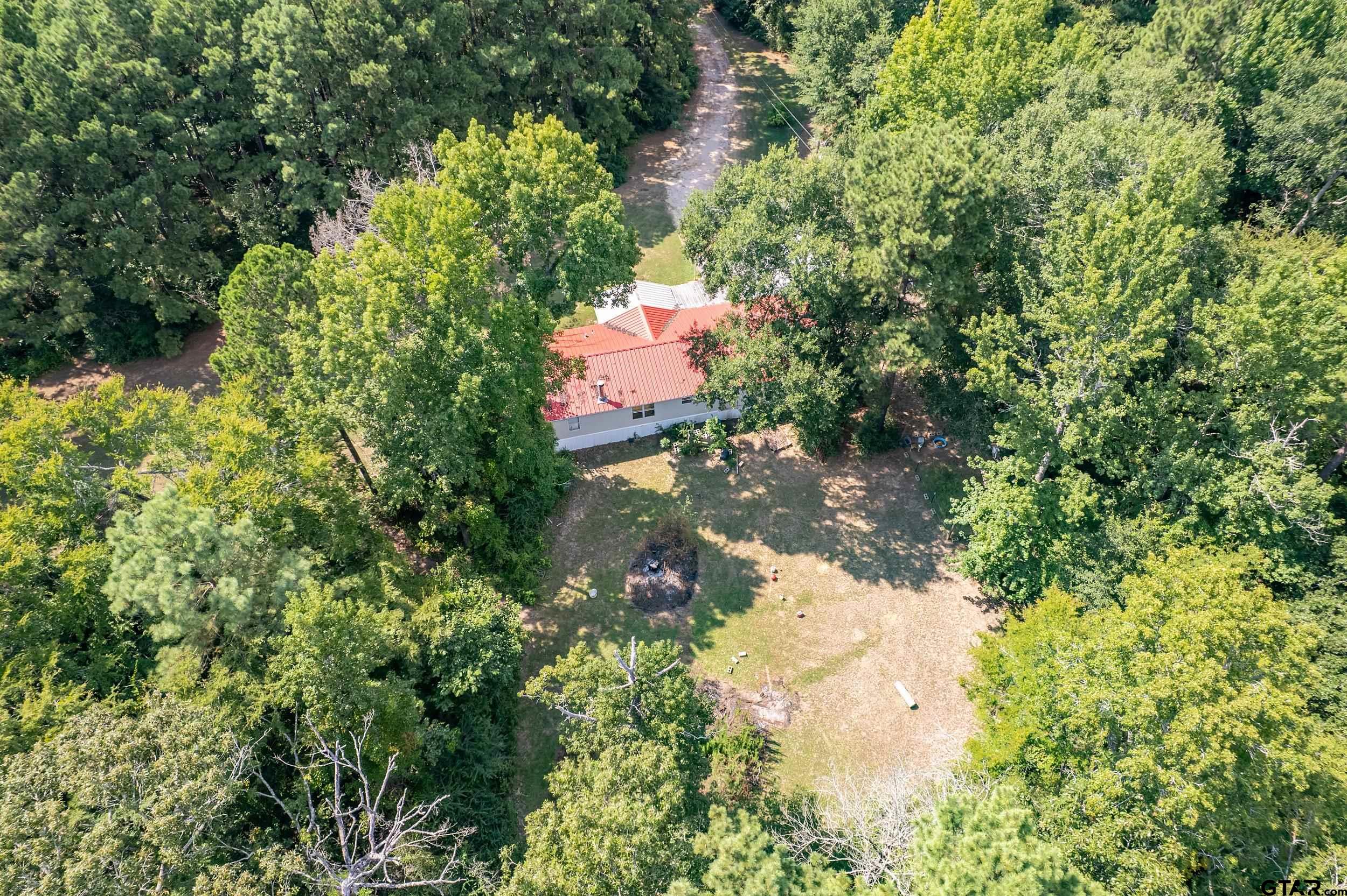 1655 County Road 2120 Rusk, TX 75785 - Photo 10 of 37 a backyard of a house with a yard and outdoor seating