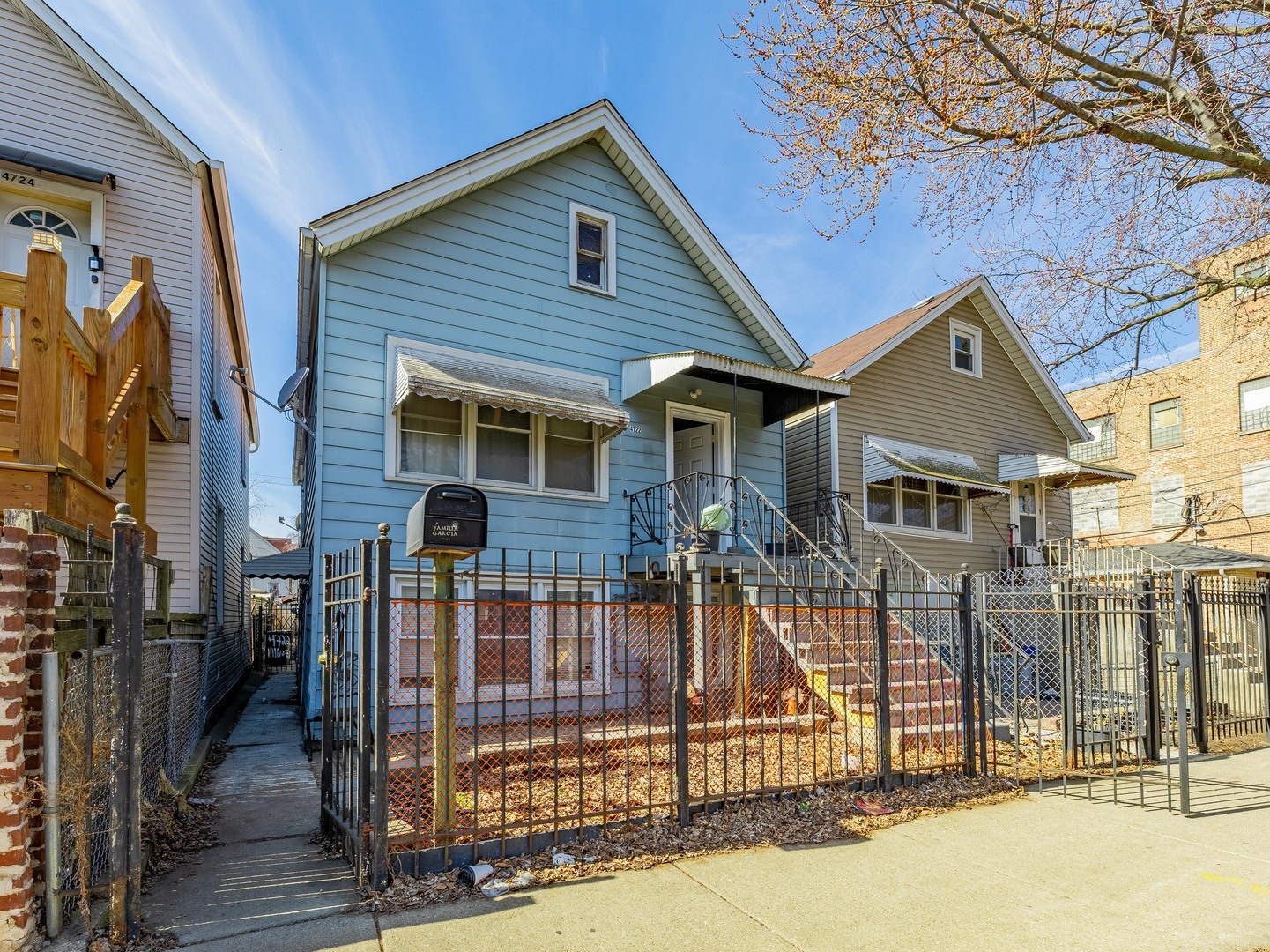 4722 South Ada Street Chicago, IL 60609 - Photo 13 of 14 front view of a house with a small yard