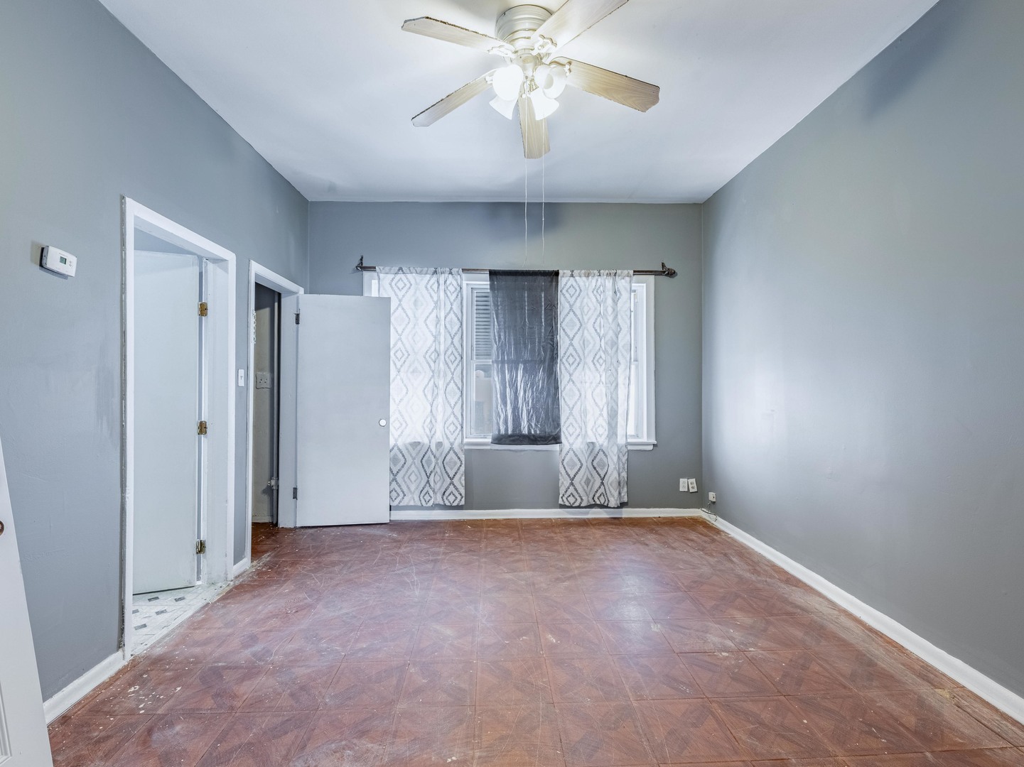 4722 South Ada Street Chicago, IL 60609 - Photo 3 of 14 a view of an empty room with chandelier fan and window
