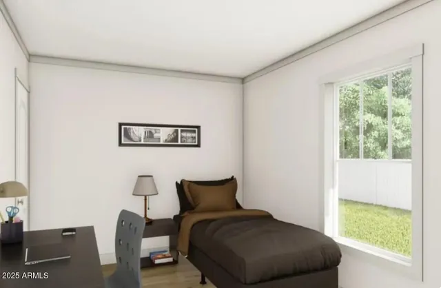 a bedroom with a bed and a window