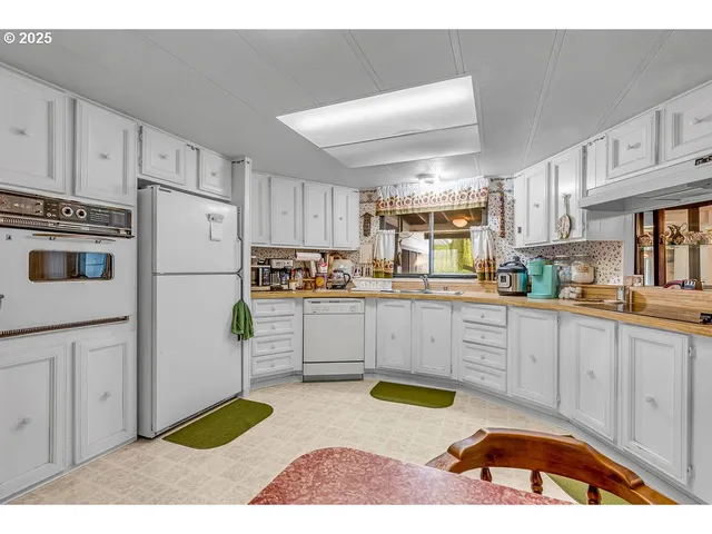a kitchen with stainless steel appliances kitchen island granite countertop a refrigerator sink and stove