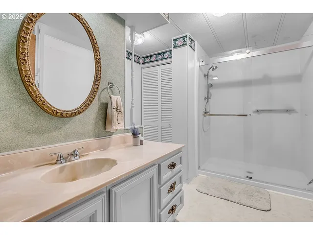 a bathroom with a sink double vanity and a mirror