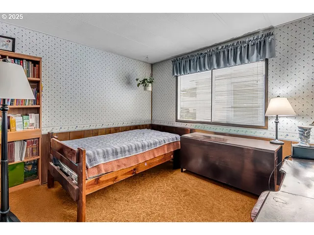 a bedroom with a bed and window