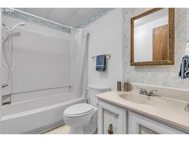 a bathroom with a sink toilet a mirror and shower