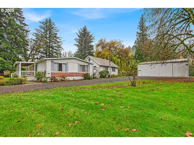 a front view of a house with yard and green space
