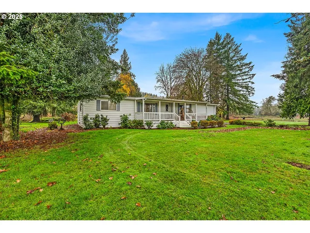 a front view of a house with a yard table and chairs