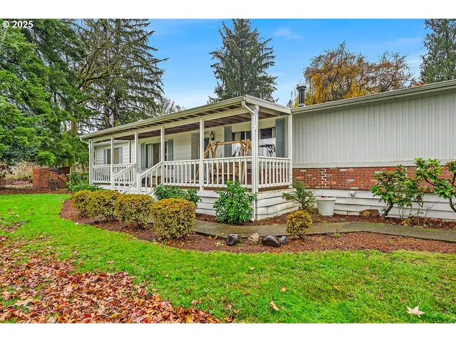 a front view of a house with a garden