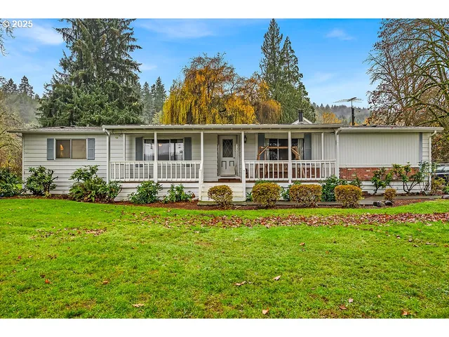 a view of a house with backyard sitting area and garden