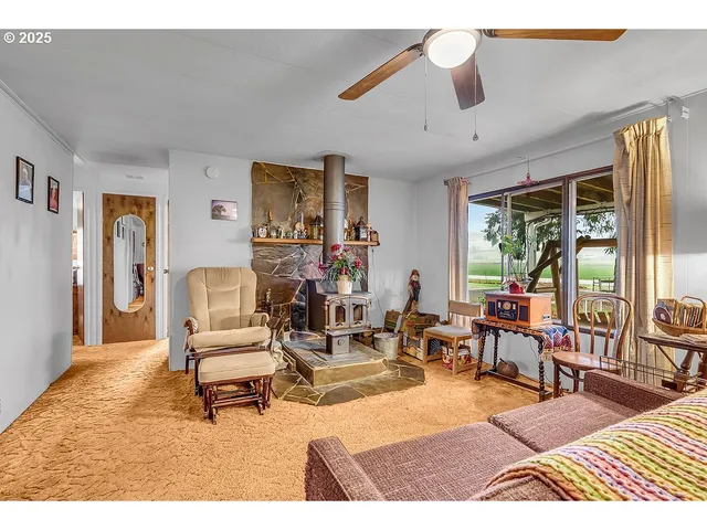 a living room with furniture dining table and a large window