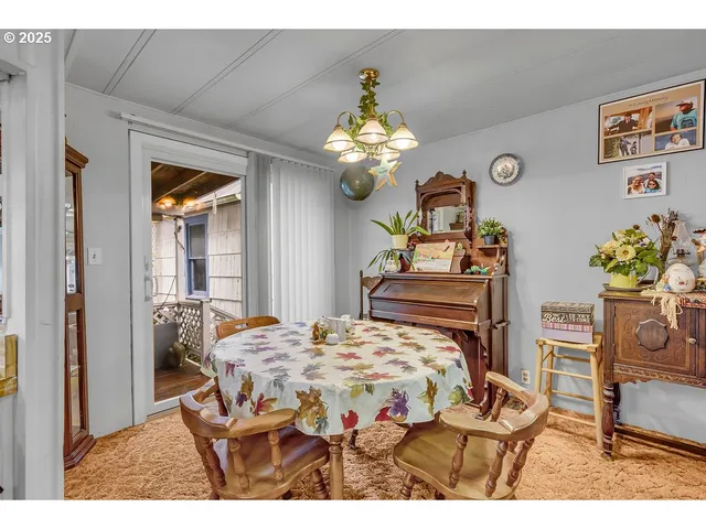 a bedroom with a bed table and a chandelier
