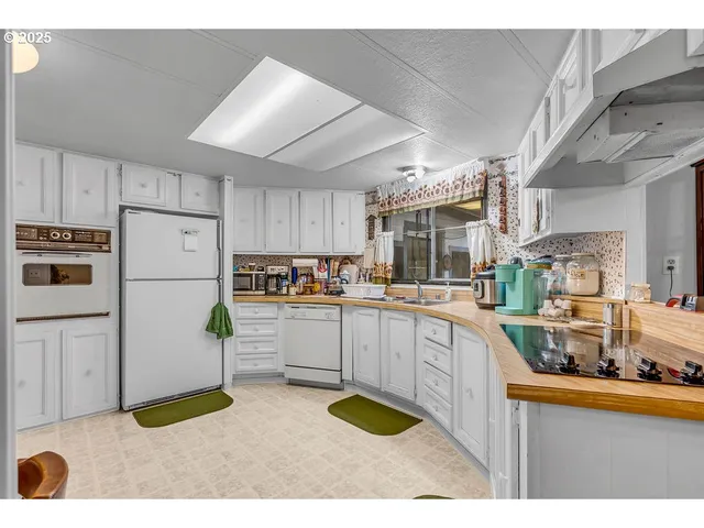 a kitchen with refrigerator and cabinets