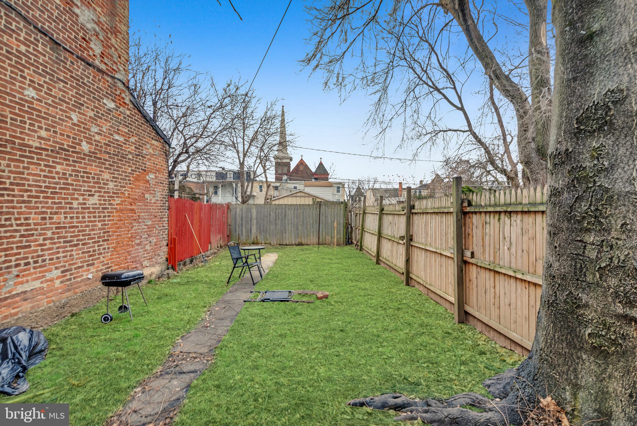 423 North Hall Street Allentown, PA 18102 - Photo 14 of 18 a view of backyard with wooden fence and a large tree