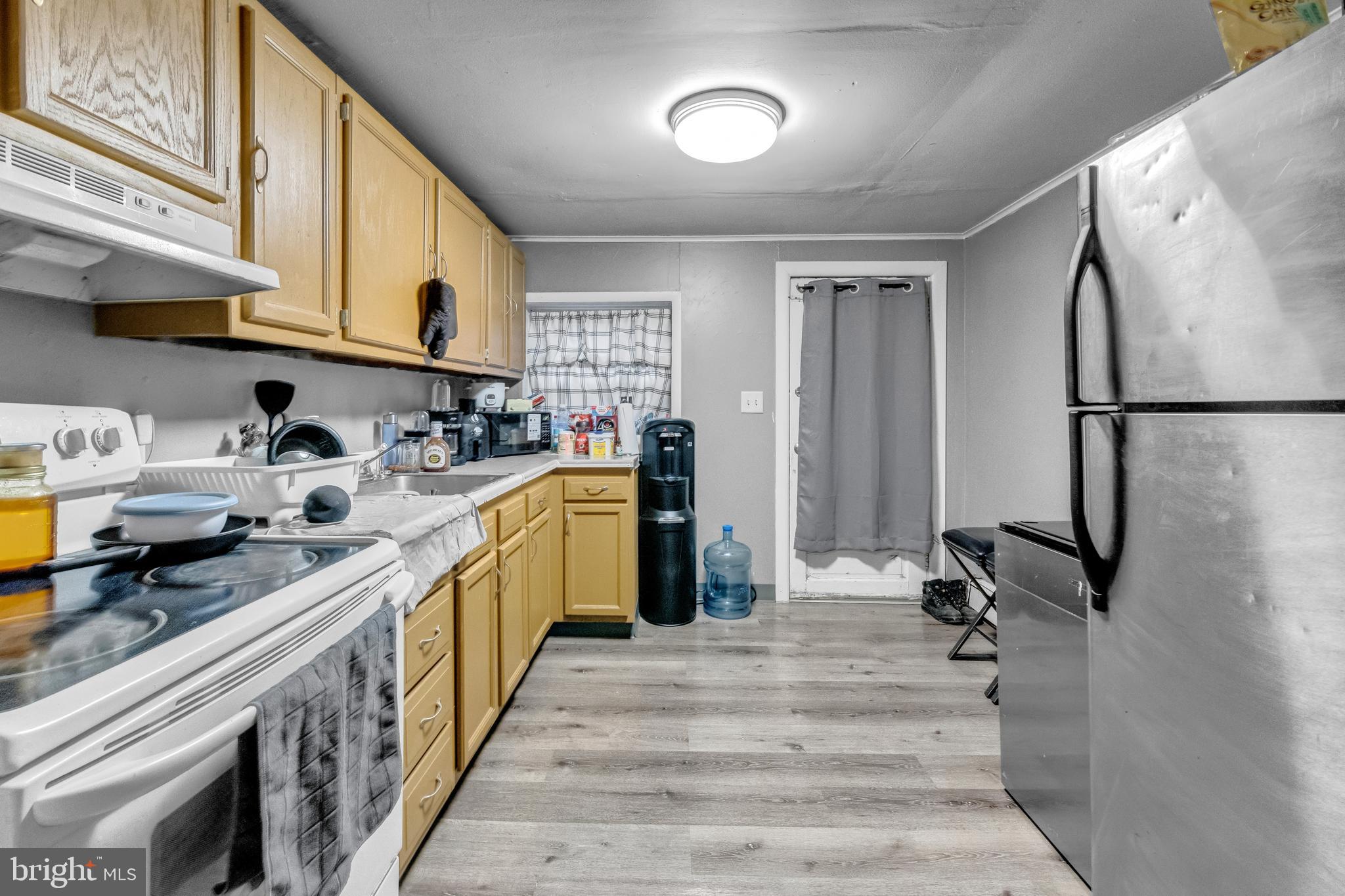 423 North Hall Street Allentown, PA 18102 - Photo 3 of 18 a kitchen with sink a refrigerator and cabinets