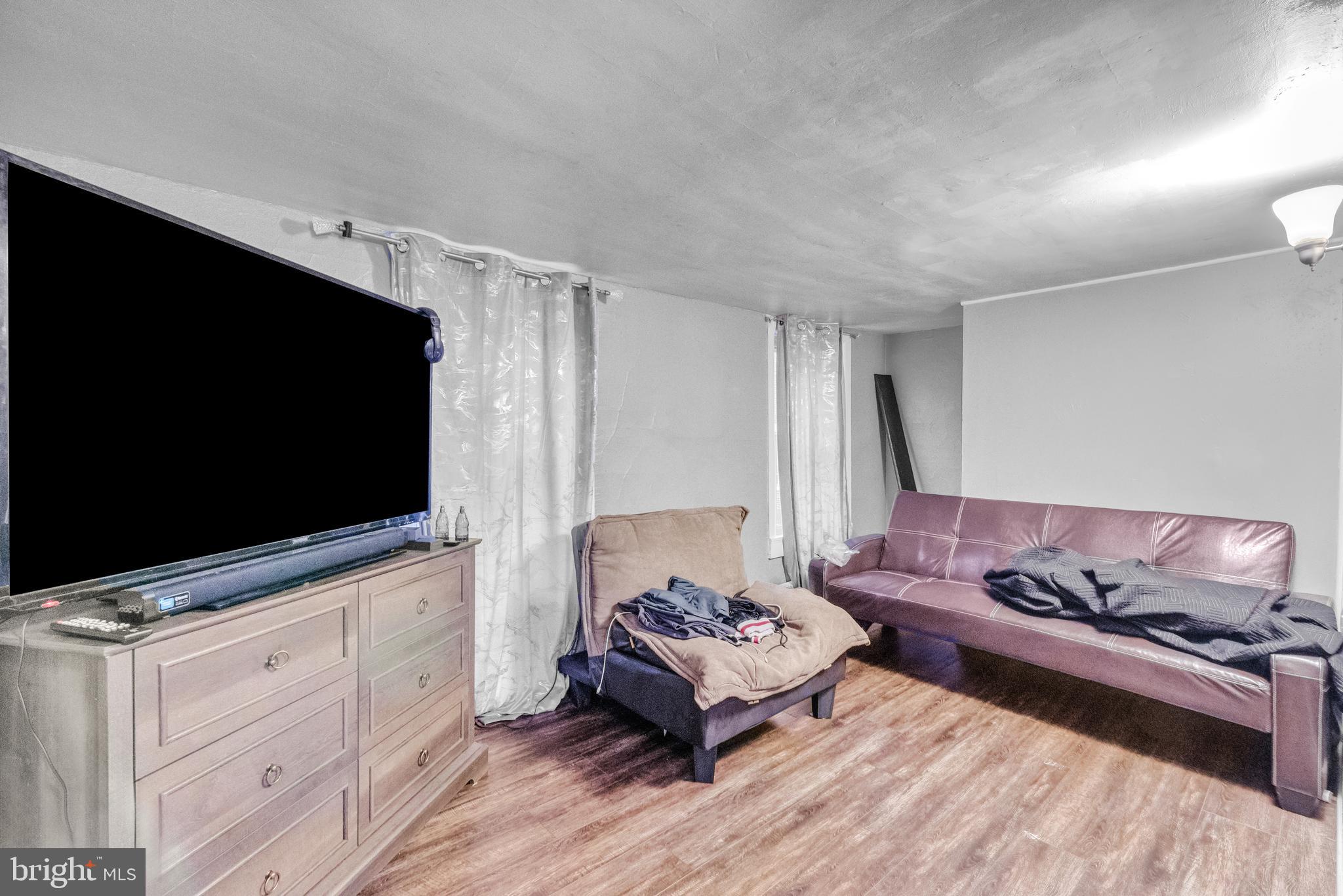 423 North Hall Street Allentown, PA 18102 - Photo 10 of 18 a living room with furniture and a flat screen tv