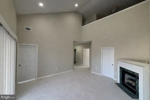 a view of an empty room with a fireplace