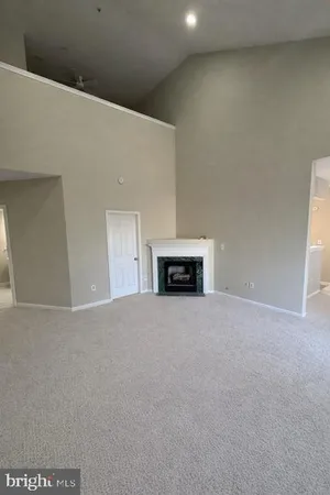 a view of empty room with a fireplace