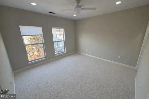 an empty room with windows and closet