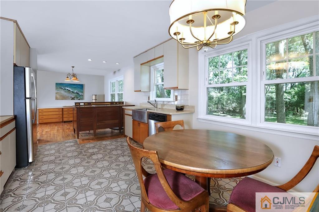 17 Taylor Road Monmouth Junction, NJ 08852 - Photo 11 of 25 a dining room with furniture a rug and a floor to ceiling window