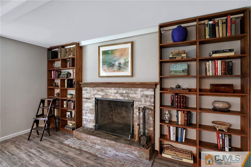 17 Taylor Road Monmouth Junction, NJ 08852 - Photo 15 of 25 a living room with lots of books and a book shelf