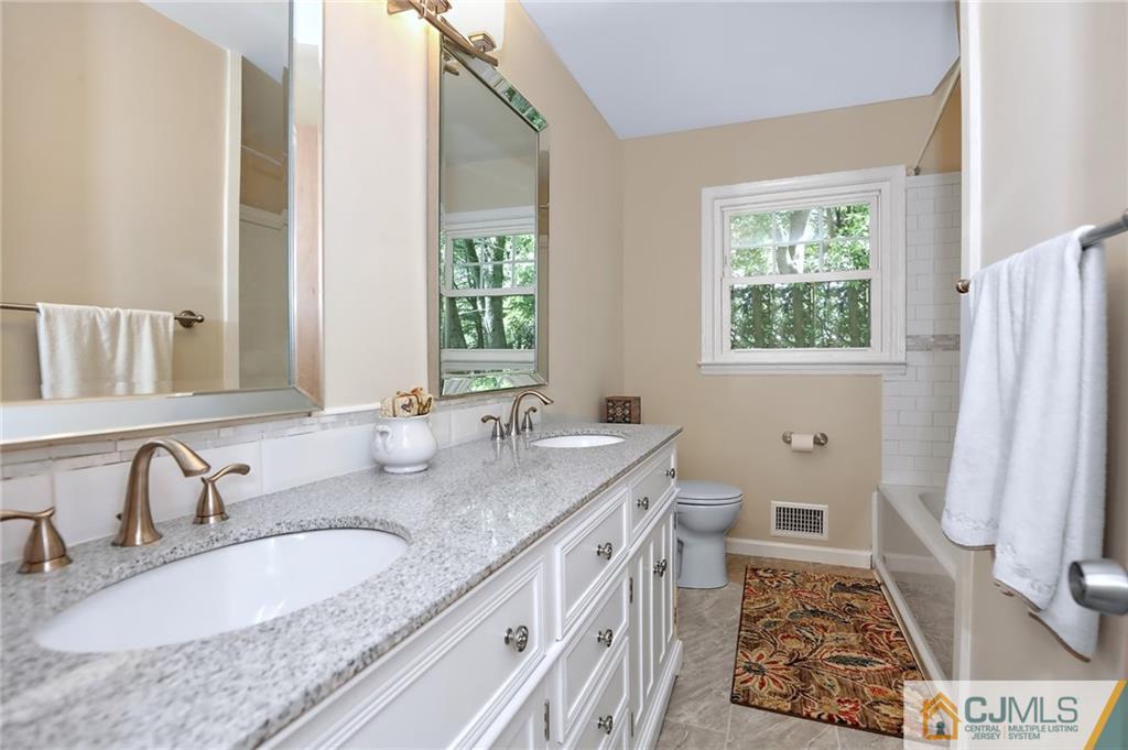 17 Taylor Road Monmouth Junction, NJ 08852 - Photo 21 of 25 a bathroom with a granite countertop double vanity sink and a mirror
