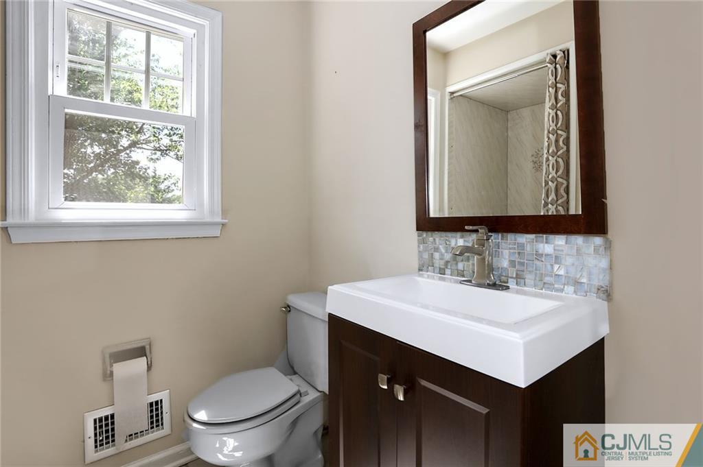 17 Taylor Road Monmouth Junction, NJ 08852 - Photo 22 of 25 a bathroom with a toilet sink and mirror