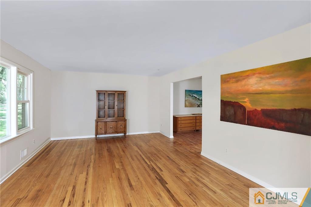 17 Taylor Road Monmouth Junction, NJ 08852 - Photo 5 of 25 an empty room with wooden floor and windows