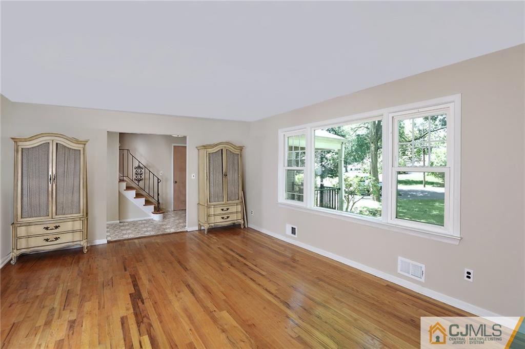 17 Taylor Road Monmouth Junction, NJ 08852 - Photo 7 of 25 a view of an empty room with wooden floor and a window