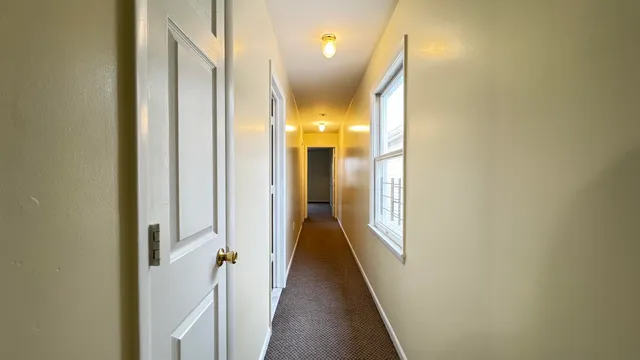a kitchen with a refrigerator sink and cabinets