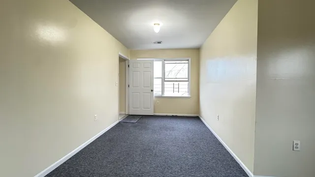 a view of a hallway with a kitchen