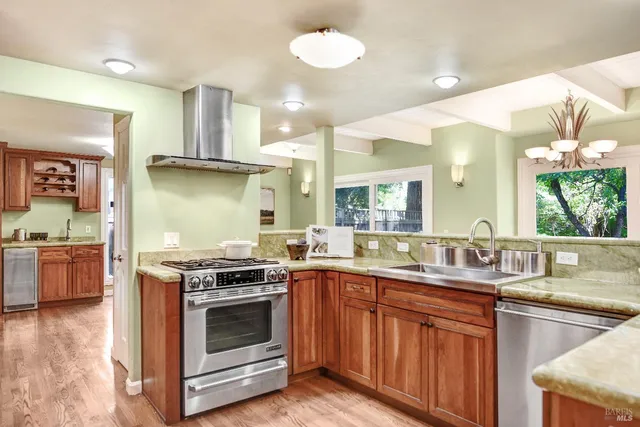 a kitchen with granite countertop stainless steel appliances and wooden cabinets