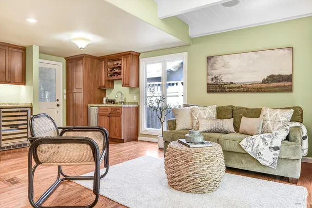 a living room with furniture and a painting