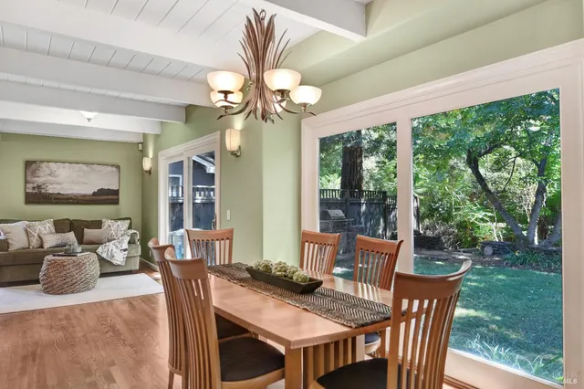 a view of a dining room with furniture wooden floor and chandelier
