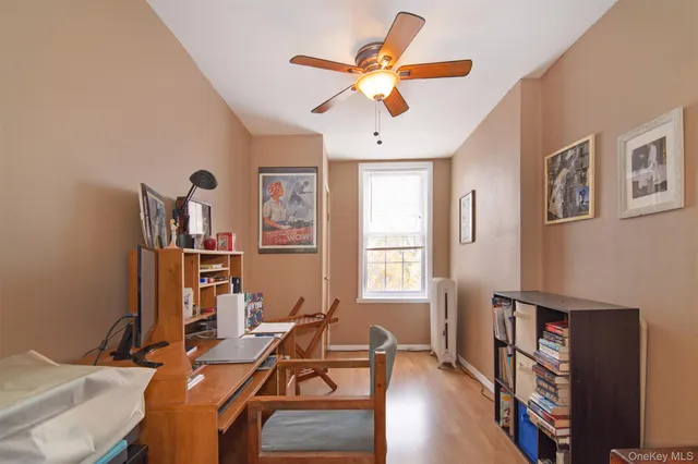 a room with furniture a bookshelf and a window