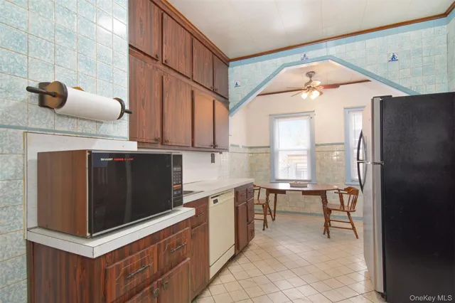 a kitchen with stainless steel appliances a stove a sink and a microwave
