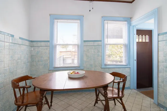 a view of a dining room with furniture and window