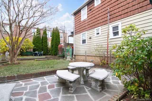 a view of a backyard with table and chairs and potted plants