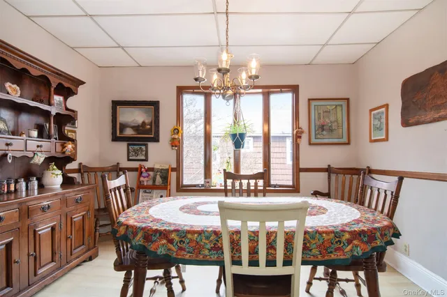 a bedroom with a bed a bookshelf and a chandelier