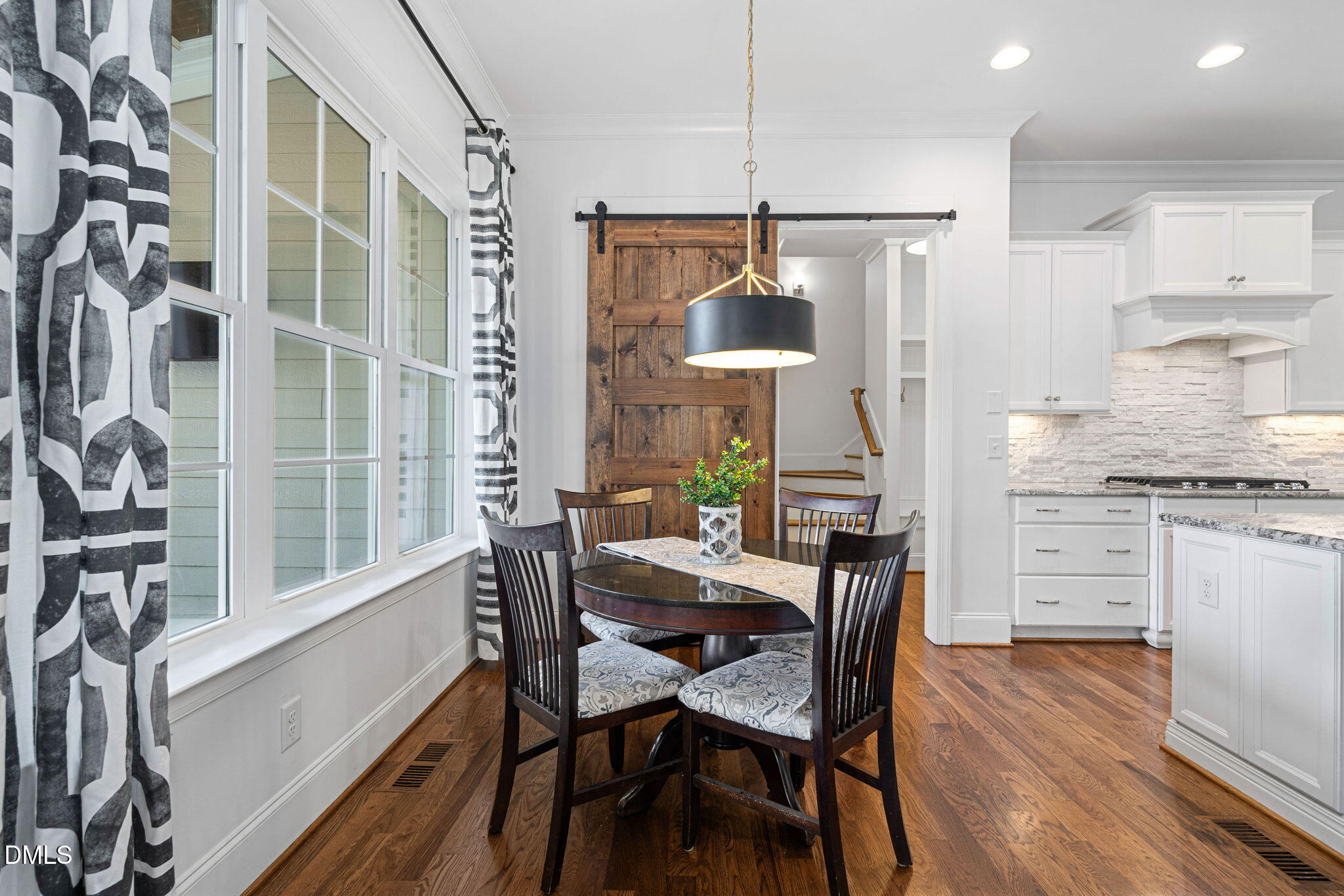 2414 Vetrina Way Apex, NC 27502 - Photo 12 of 60 a view of a dining room with furniture window and wooden floor