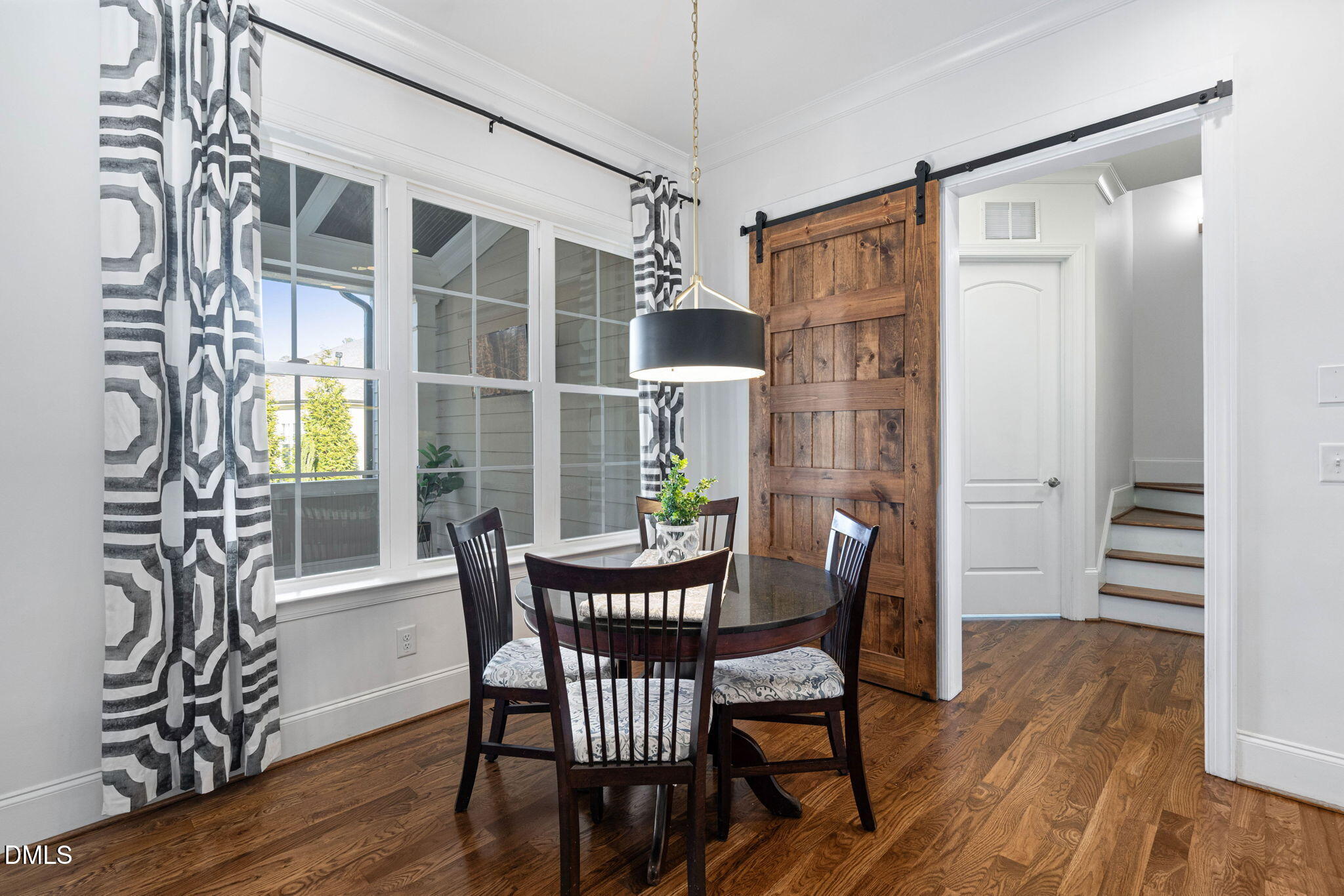 2414 Vetrina Way Apex, NC 27502 - Photo 13 of 60 a view of a dining room with furniture window and wooden floor