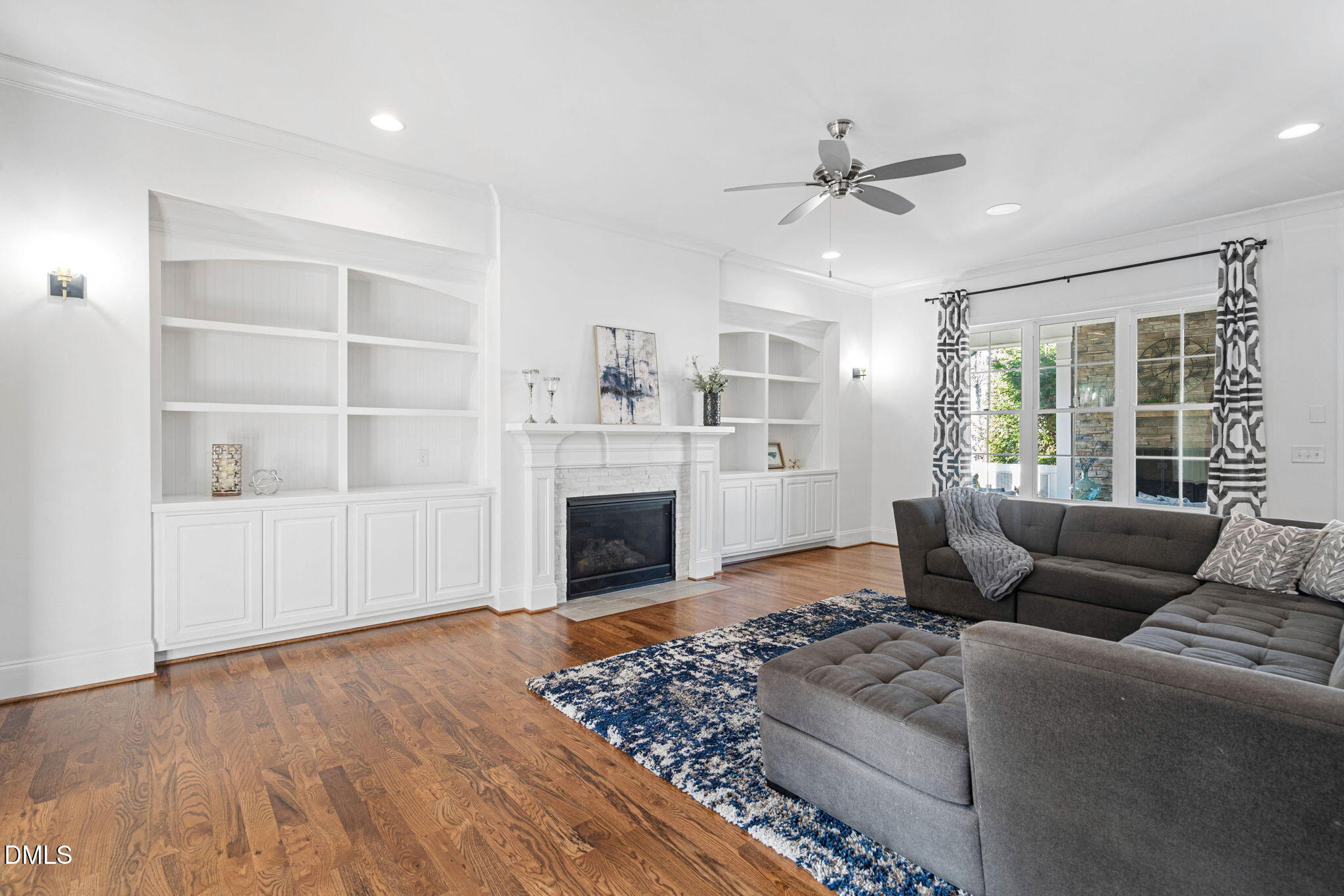 2414 Vetrina Way Apex, NC 27502 - Photo 16 of 60 a living room with furniture and a fireplace