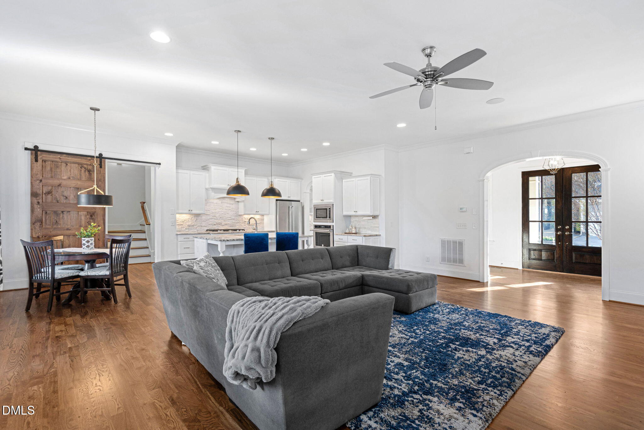 2414 Vetrina Way Apex, NC 27502 - Photo 18 of 60 a living room with furniture and a wooden floor