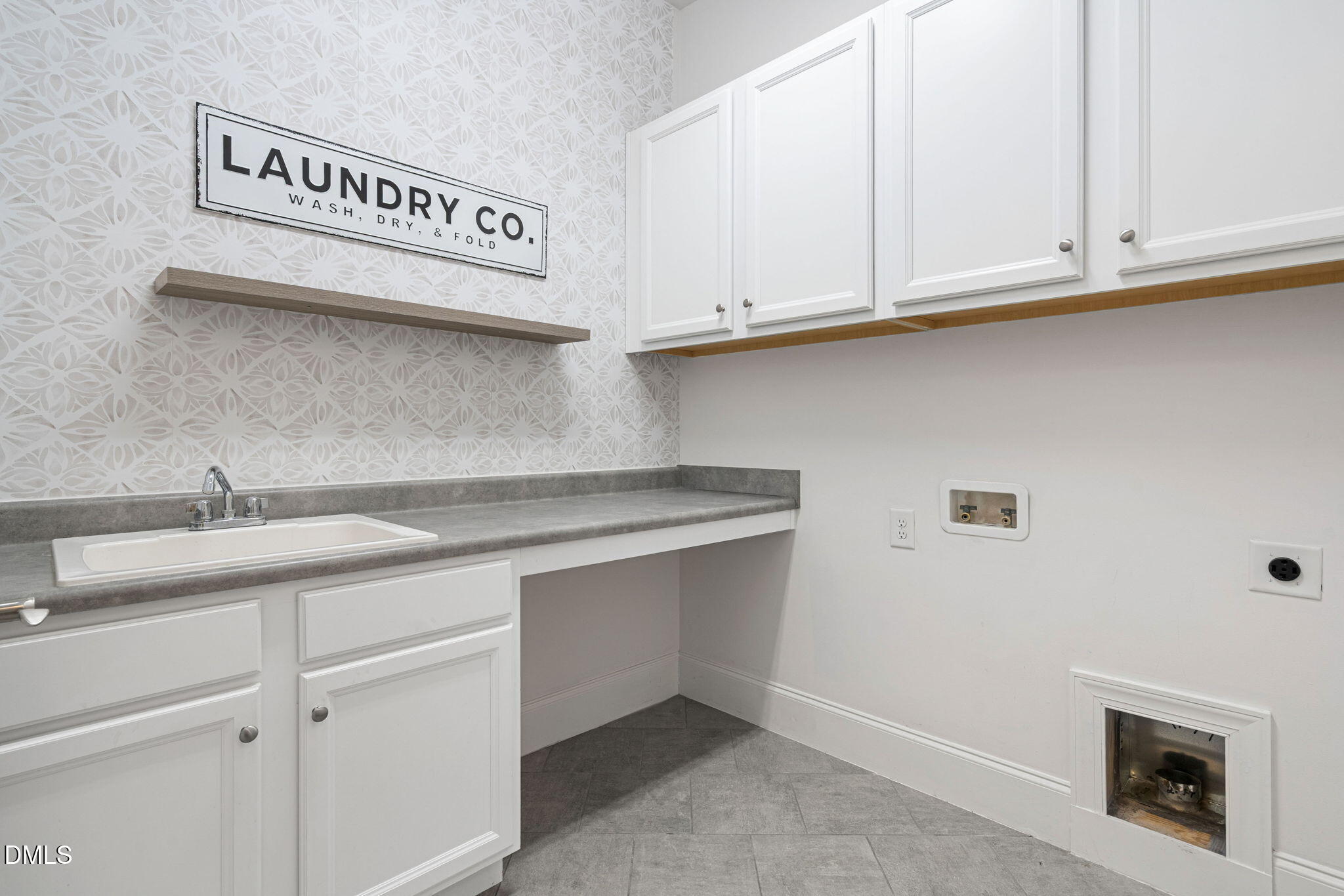 2414 Vetrina Way Apex, NC 27502 - Photo 32 of 60 a kitchen with white cabinets and a sink