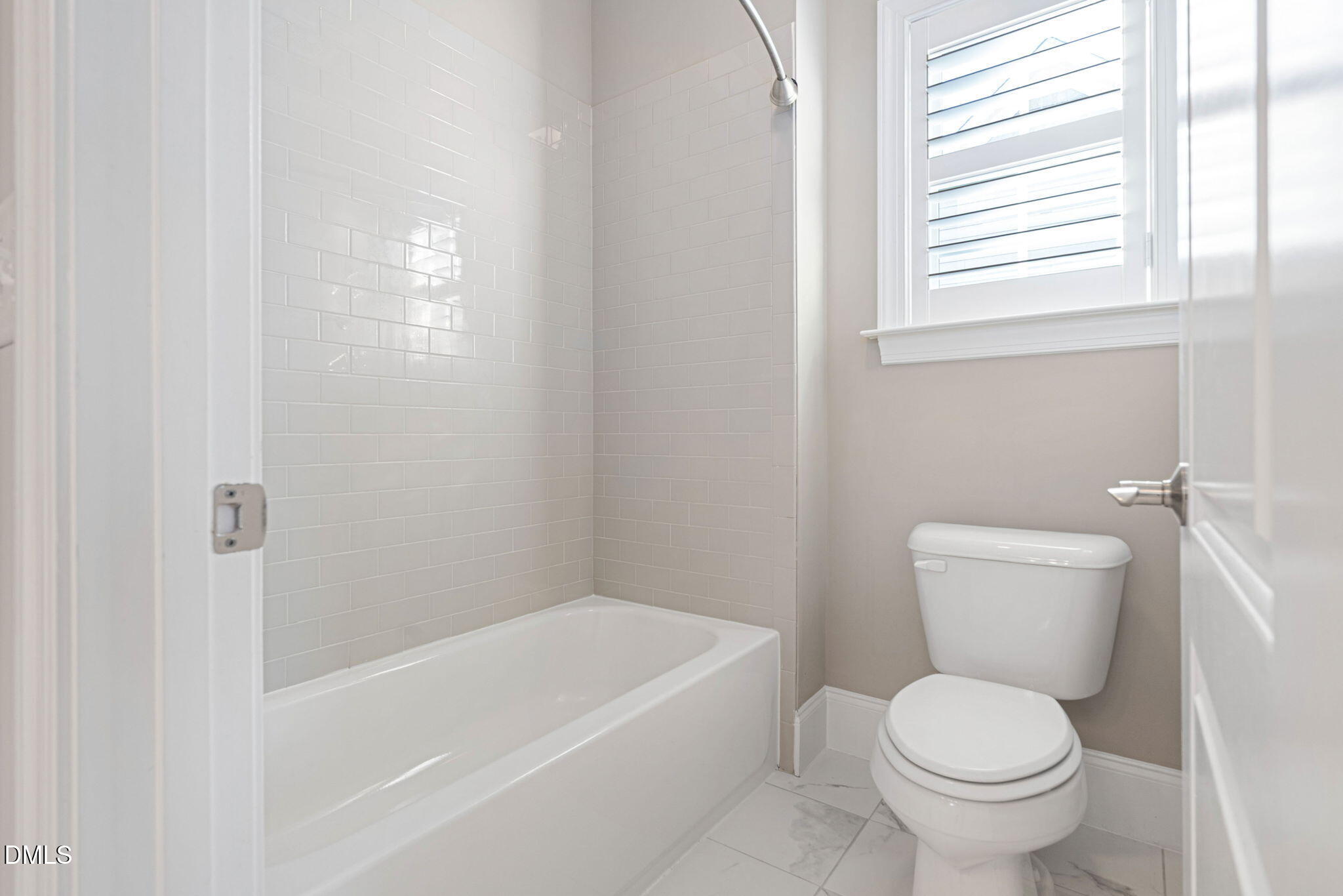 2414 Vetrina Way Apex, NC 27502 - Photo 41 of 60 a white toilet sitting next to a bath tub