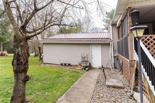 a view of a house with a yard and a wooden deck