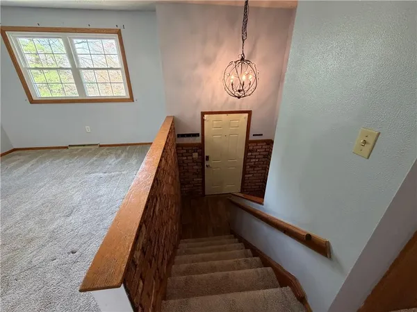 a view of a room with wooden floor and windows
