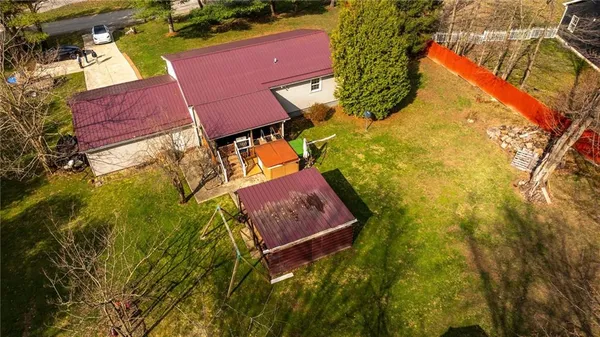 an aerial view of a house with a yard swimming pool and outdoor seating