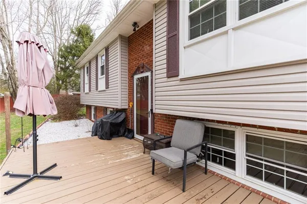 a view of a table and chairs in back yard of the house