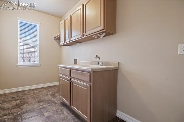 a kitchen with granite countertop white cabinets and black appliances