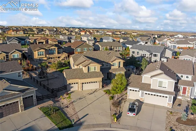 a open kitchen with granite countertop a stove top oven a sink dishwasher a dining table and chairs with wooden floor